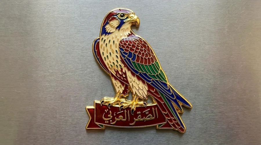 Arabian falcon enamel magnet with an Al Saqr Al Arabi Arabic ribbon