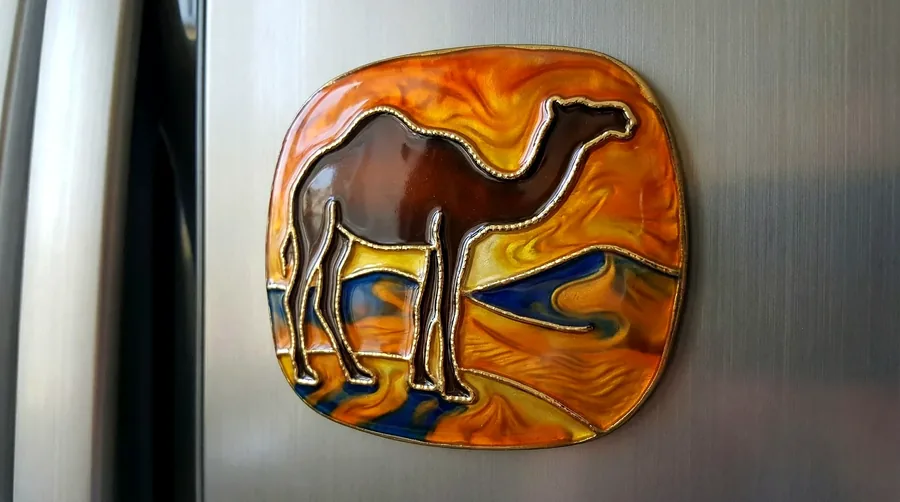 Camel silhouette enamel magnet with a desert sunset in swirled enamel